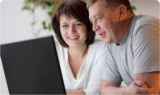 Un homme et une femme consultent les informations d'une parcelle sur leur ordinateur
